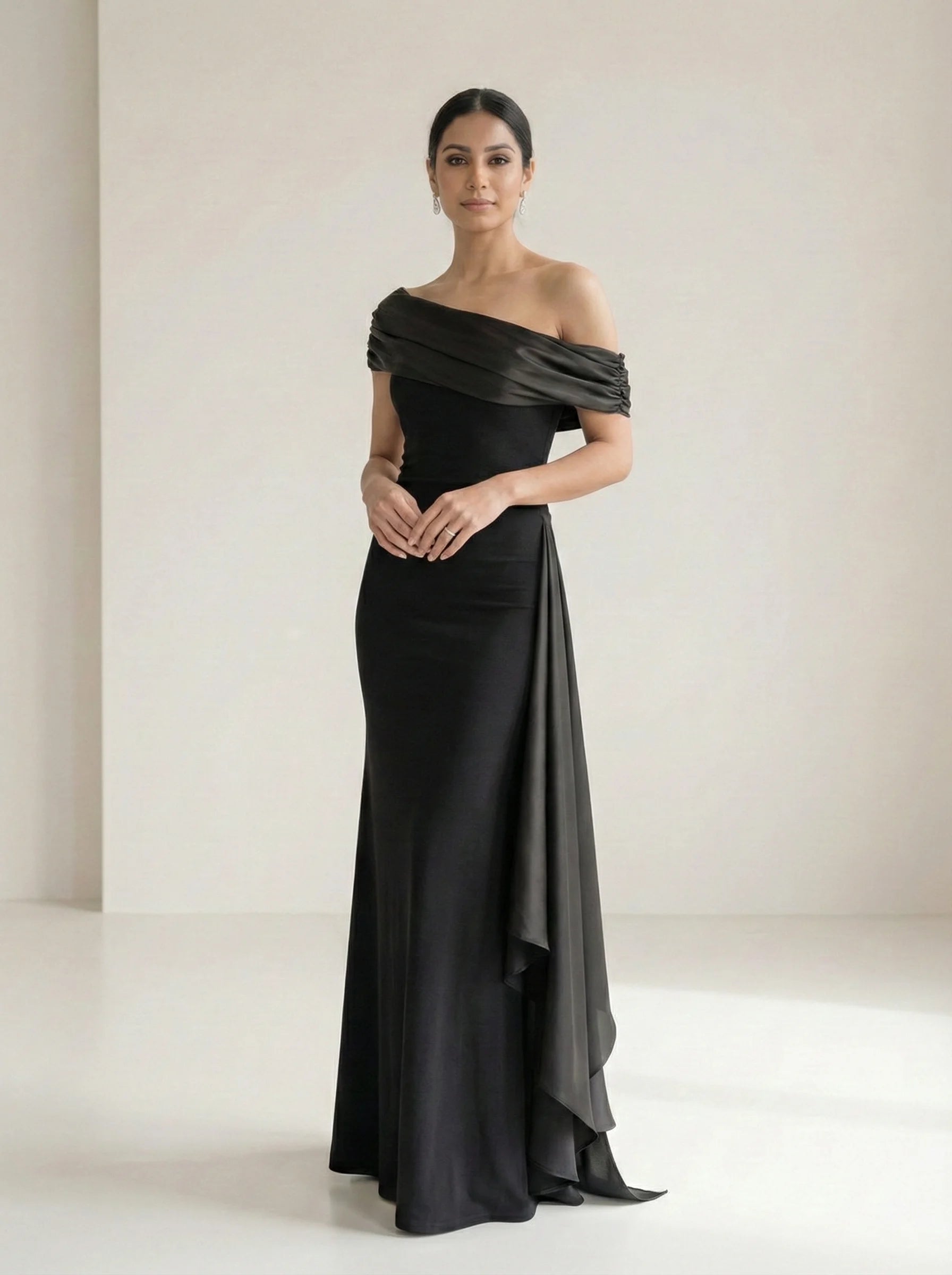 Elegant front pose of SwanClad black off-shoulder maxi dress highlighting fitted bodice and flowing maxi length.