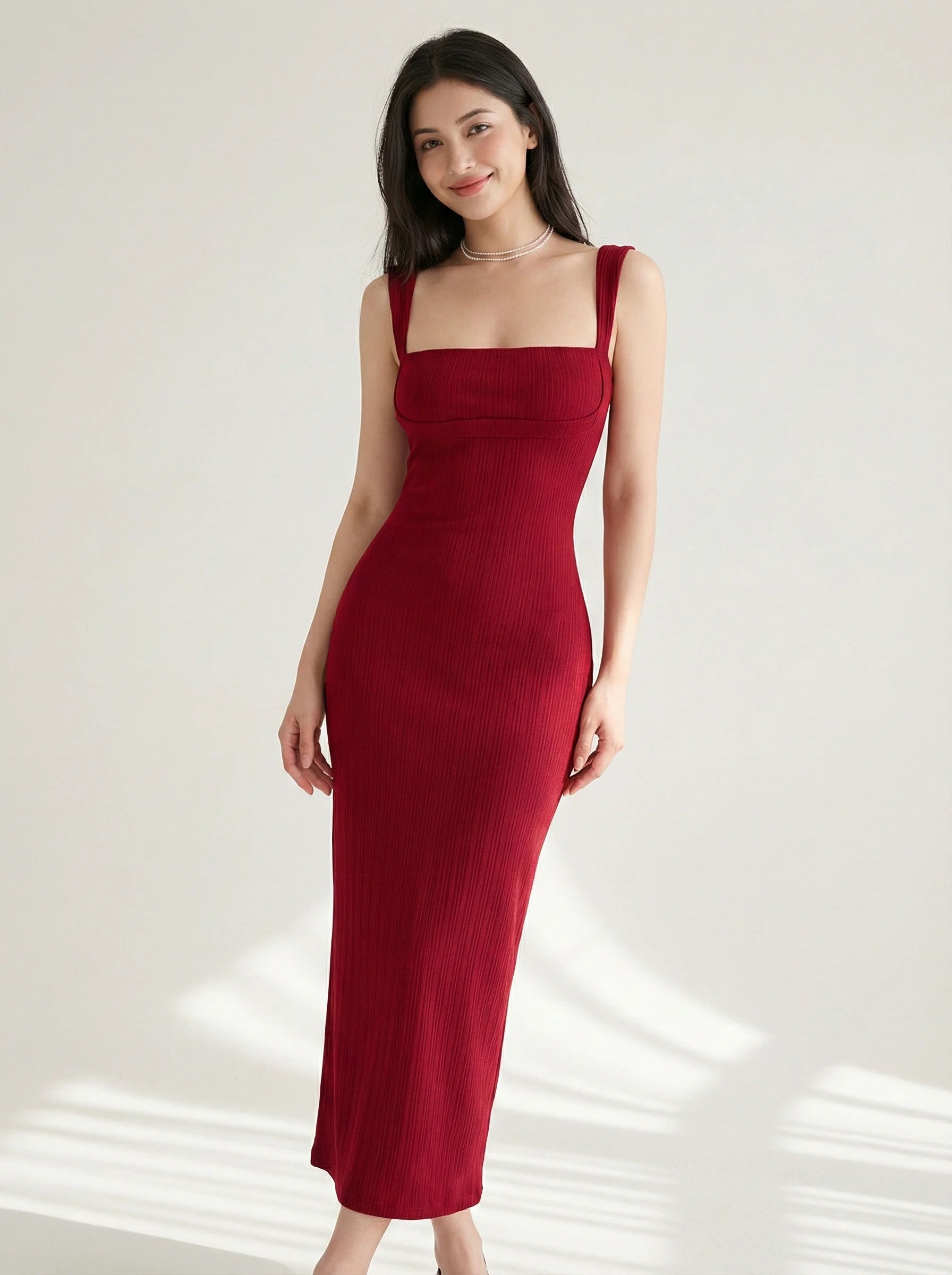Angled front view of SwanClad Red Solid Sleeveless Midi Bodycon Dress displaying body-hugging fit and minimal design
